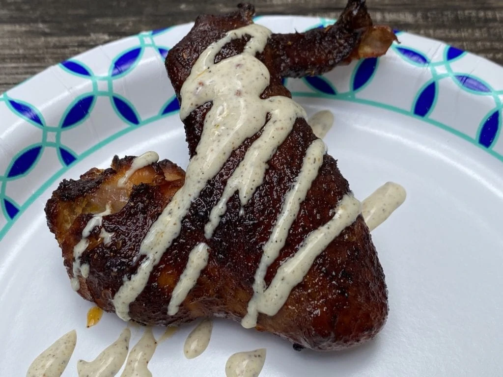 Smoked chicken wings drizzled with Alabama white BBQ sauce