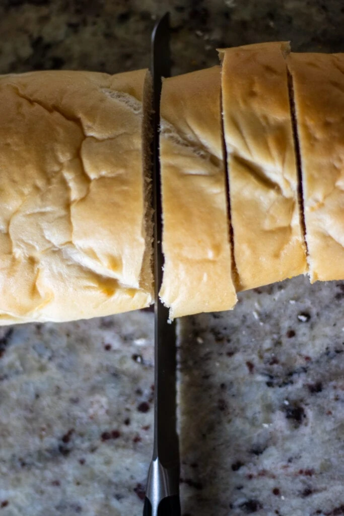 Bread being sliced by a knife