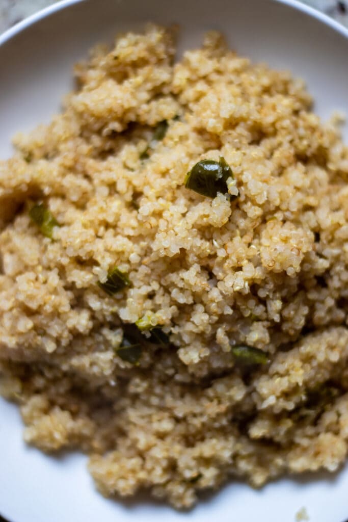 Close up of quinoa with flecks of jalapeño pepper. 