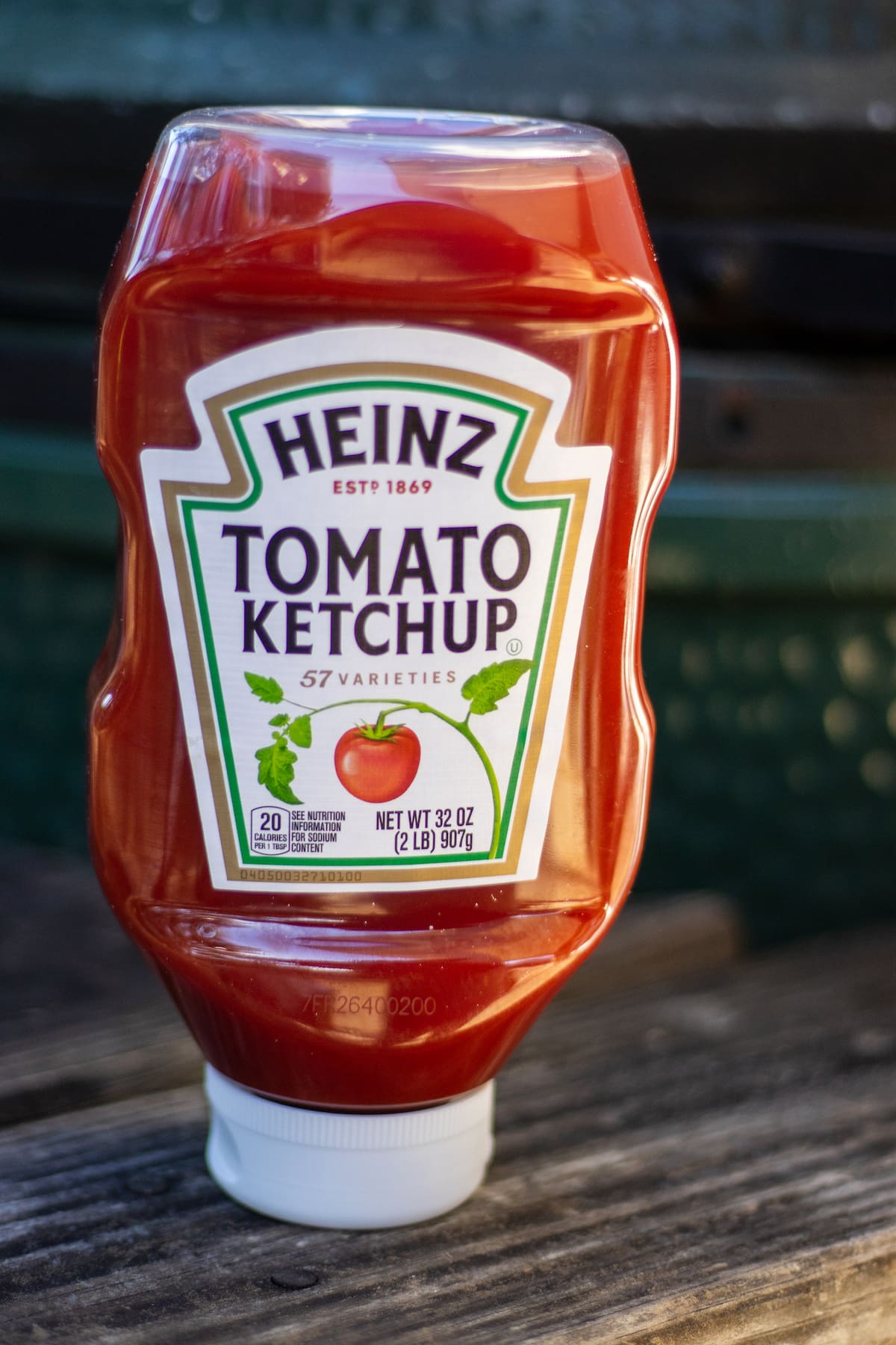 A bottle of Heinz ketchup on a wooden table