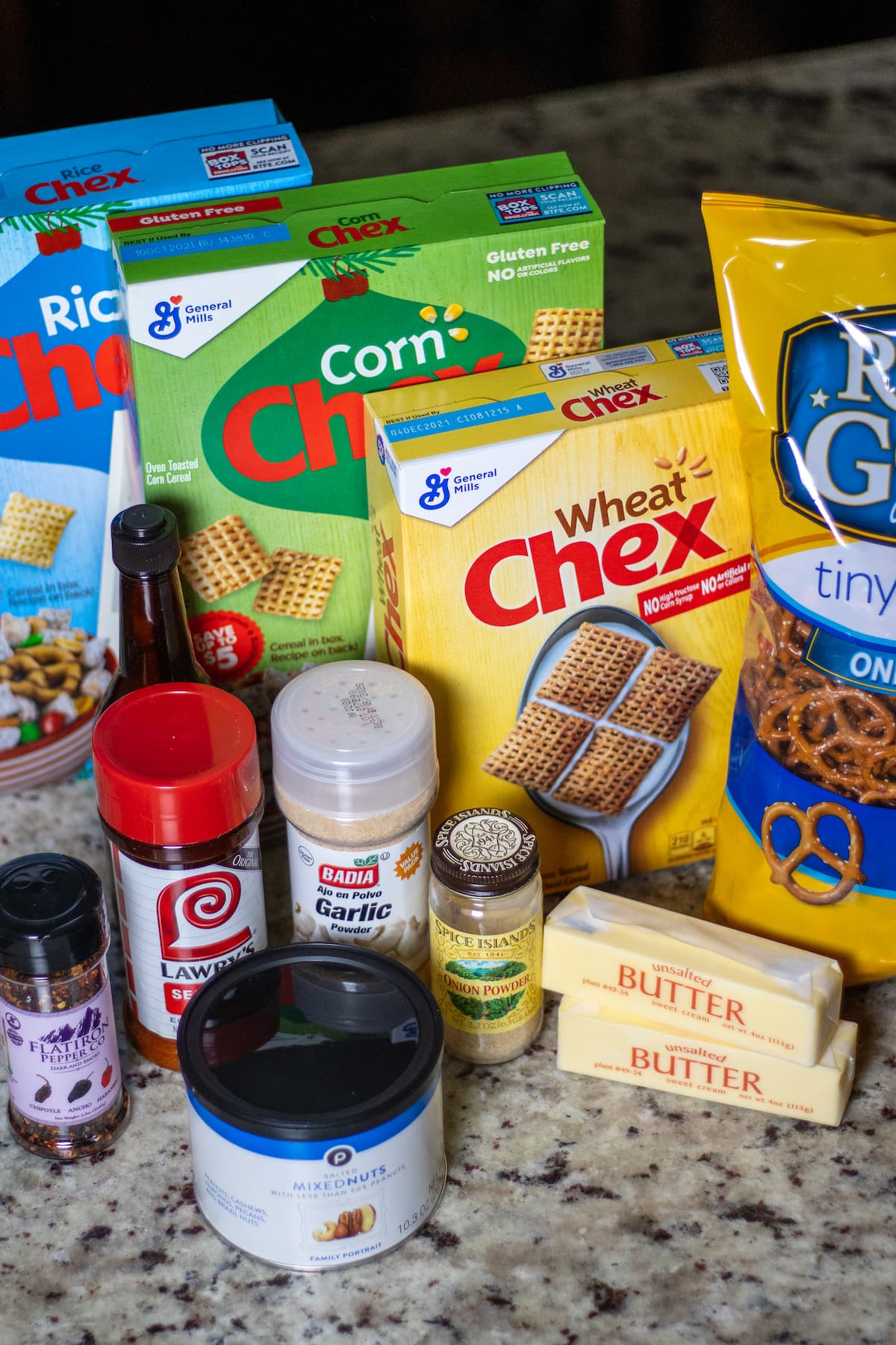 All the ingredients for Chex Mix! Each box of cereal, butter, pretzels, nuts, and the seasonings. 