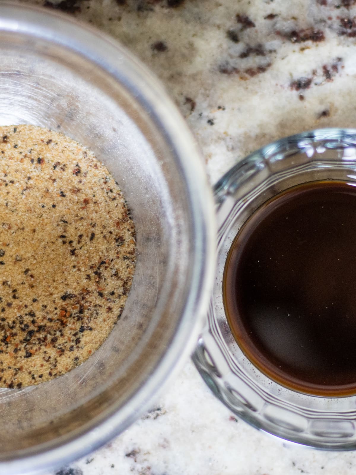 Seasoning mix in a metal bowl and Worcestershire sauce in a small glass bowl beside the it.