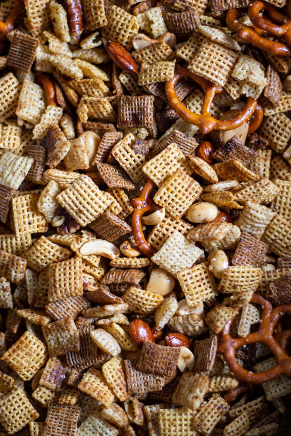 Close up of Chex Mix Recipe, nuts, Chex, and pretzels.