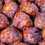 brilliantly red meatballs covered with sticky bbq sauce