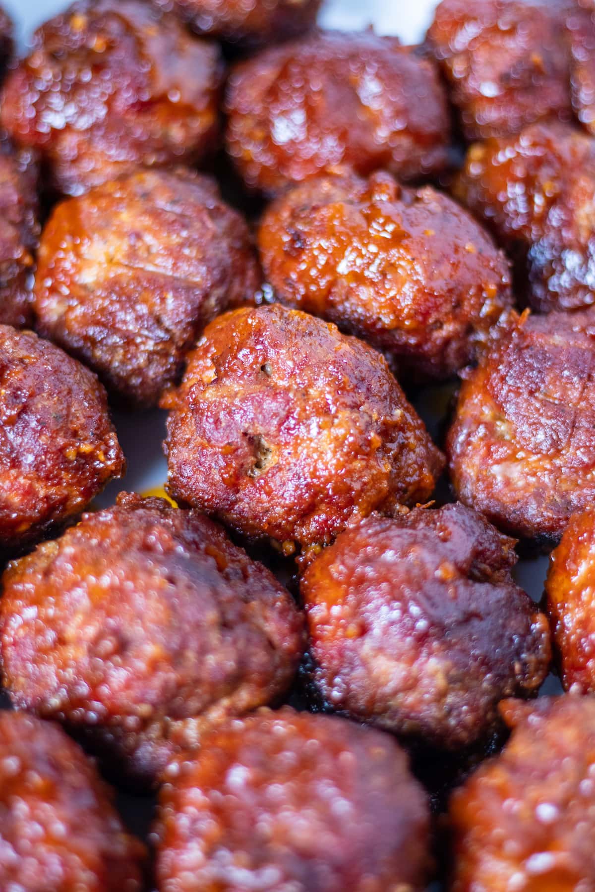 brilliantly red meatballs covered with sticky bbq sauce