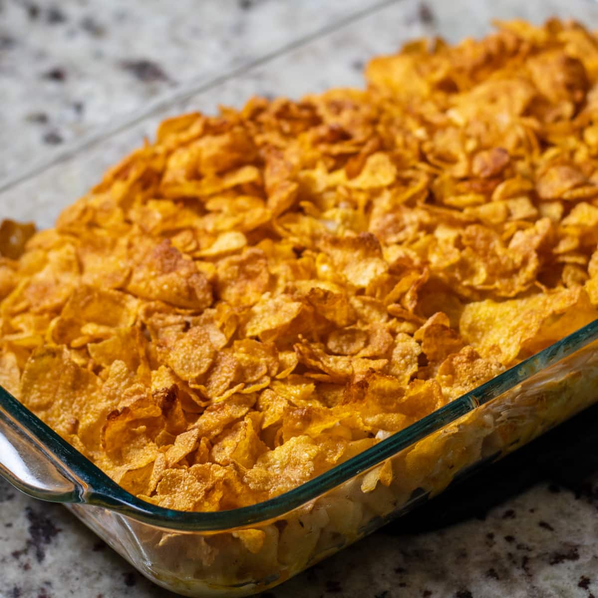 close up of hashbrown casserole in a glass baking dish