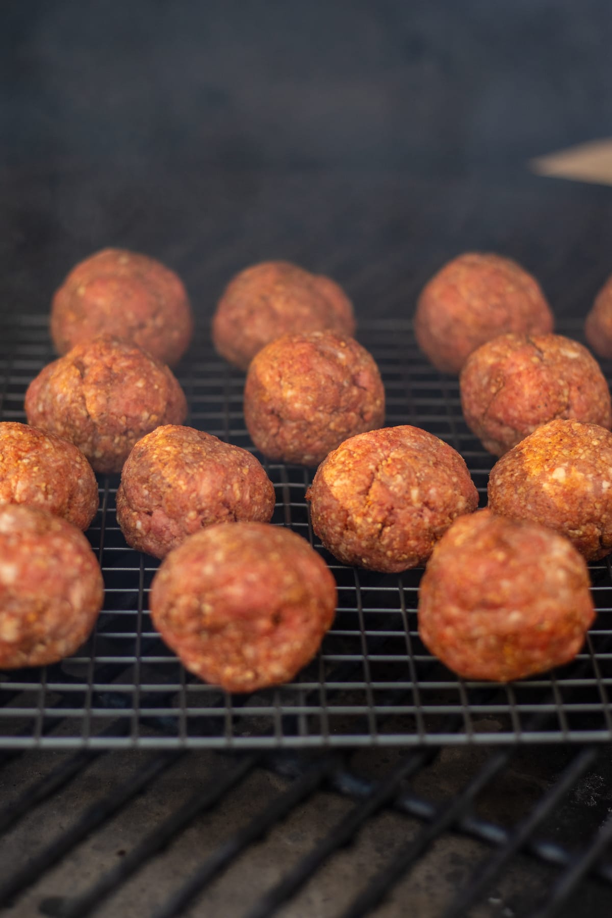 raw meatballs on the smoker