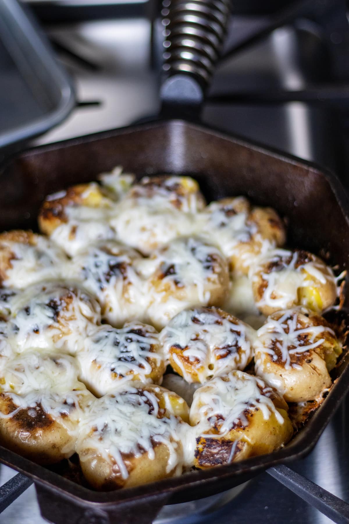 Melted chases in a skillet on potatoes. 